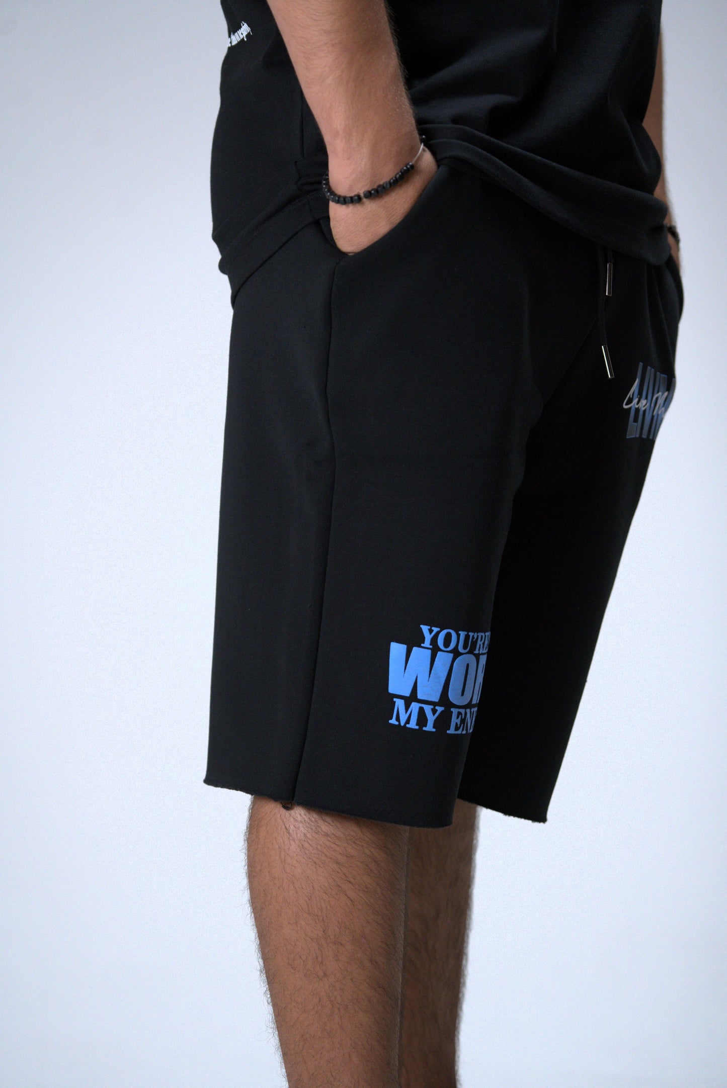 Black shorts with blue text on a white background